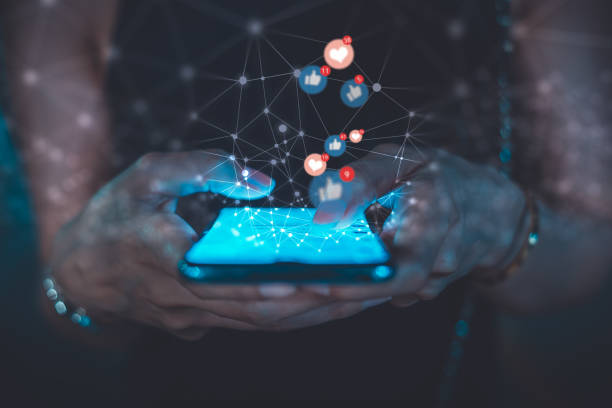 Hands holding a phone with social media engagement icons
